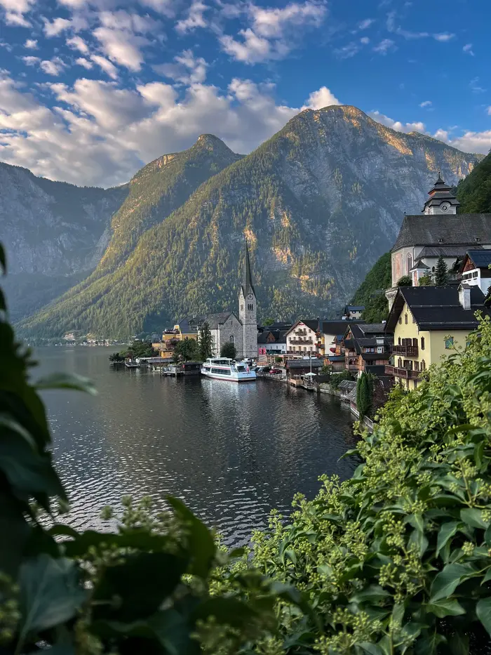 The classic Hallstatt viewpoint framed by green leaves