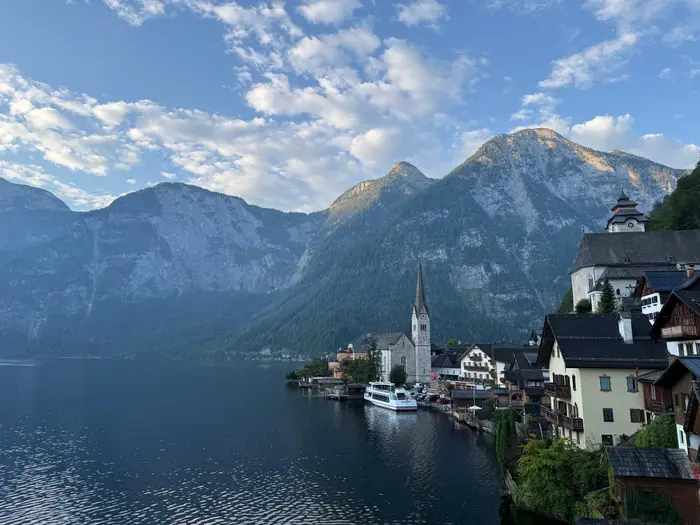 Hallstatt village and church viewed along the lakeside in morning light