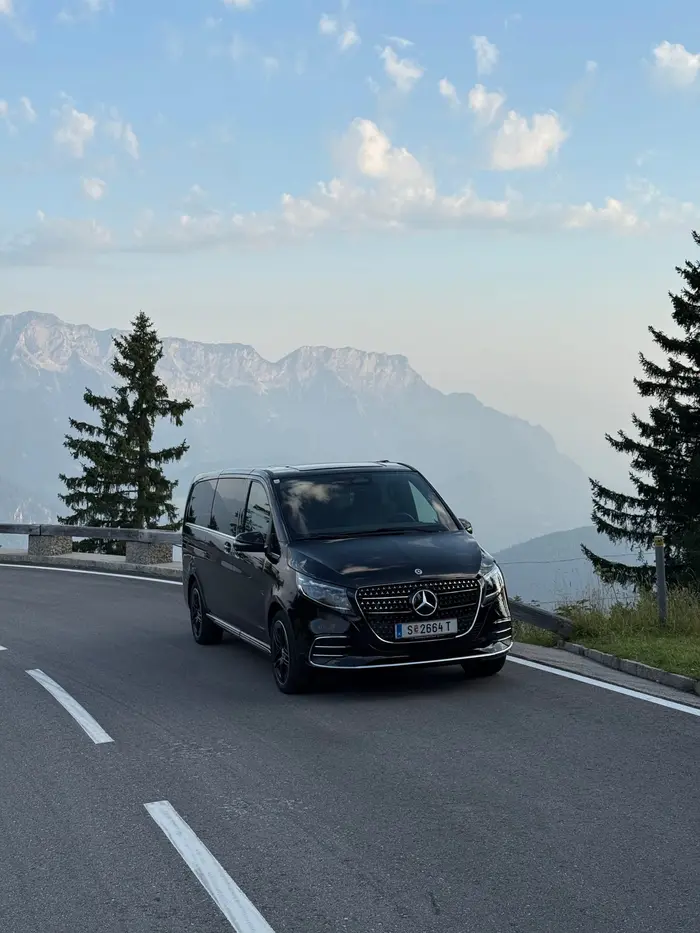 Our black Mercedes V-Class tour van on an alpine mountain road